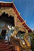 Chiang Mai - The Wat Phra Singh temple. The large Viharn Luang (main prayer hall) the guardians of the stairs shaped as a Naga coming out from the mouth of a Makkara. 